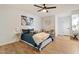 Comfortable main bedroom with wood floors and a view of the backyard at 10839 W Peoria Ave, Sun City, AZ 85351