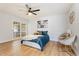 Cozy main bedroom with a comfortable bed, stylish decor, and wood flooring at 10839 W Peoria Ave, Sun City, AZ 85351