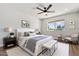 Beautifully staged main bedroom suite with a cozy sitting area and plenty of natural light at 10839 W Peoria Ave, Sun City, AZ 85351