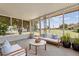 Relaxing sunroom with comfortable seating to enjoy the views of the community green space at 10839 W Peoria Ave, Sun City, AZ 85351