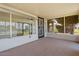 View of the enclosed back porch/sunroom with white brick trim and view of the outdoors at 10839 W Peoria Ave, Sun City, AZ 85351