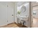 Chic vanity area with a round mirror, marble countertop, and stylish lighting at 10839 W Peoria Ave, Sun City, AZ 85351