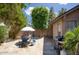Inviting backyard featuring a patio with a table and chairs, complemented by lush greenery at 1117 W Manor St, Chandler, AZ 85224