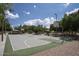 Well-maintained outdoor basketball court with multiple hoops, surrounded by lush trees in community at 1117 W Manor St, Chandler, AZ 85224