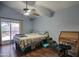 Calm bedroom featuring a ceiling fan, wood floors, a queen bed, and desk at 1117 W Manor St, Chandler, AZ 85224