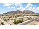 Aerial view of a desert community with scattered homes and lush trees, set against a backdrop of rugged mountains at 11912 N Thunderbird Rd, Maricopa, AZ 85139