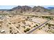 Mountains surround this desert community, captured from above, showcasing houses, land, and the scenic landscape at 11912 N Thunderbird Rd, Maricopa, AZ 85139