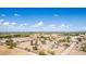 Expansive aerial view showcases a large property with rural desert charm under a bright blue sky and scattered clouds at 11912 N Thunderbird Rd, Maricopa, AZ 85139
