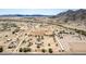 This aerial highlights desert living with homes nestled between sparse vegetation and mountains, showcasing the rugged natural beauty at 11912 N Thunderbird Rd, Maricopa, AZ 85139