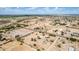 An aerial view shows a desert community with homes, roads, trees, and open spaces blending into the landscape at 11912 N Thunderbird Rd, Maricopa, AZ 85139
