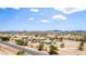 Extensive aerial view of a desert landscape showcasing rural residences and native vegetation under a brilliant blue sky at 11912 N Thunderbird Rd, Maricopa, AZ 85139