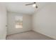 This carpeted bedroom features neutral walls and a window for natural light at 11912 N Thunderbird Rd, Maricopa, AZ 85139