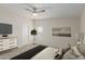 Bright bedroom features a ceiling fan, a window with blinds, and a white dresser for ample storage space at 11912 N Thunderbird Rd, Maricopa, AZ 85139
