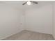 This carpeted bedroom features neutral walls and a ceiling fan at 11912 N Thunderbird Rd, Maricopa, AZ 85139