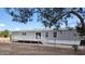 Charming single-story home features a spacious deck, white trim, and large sliding glass door at 11912 N Thunderbird Rd, Maricopa, AZ 85139