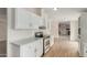 Well-lit kitchen with stainless steel range and white cabinetry at 11912 N Thunderbird Rd, Maricopa, AZ 85139