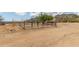 Fenced desert land with native vegetation and mountain views; a gated entry adds character to this landscape at 11912 N Thunderbird Rd, Maricopa, AZ 85139