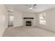 Bright living room with stone fireplace and neutral carpeting at 11912 N Thunderbird Rd, Maricopa, AZ 85139
