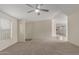 Spacious living room featuring plush carpet, neutral paint and modern ceiling fan at 11912 N Thunderbird Rd, Maricopa, AZ 85139