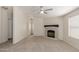 Bright living room with carpet flooring, neutral paint, stone fireplace and natural light at 11912 N Thunderbird Rd, Maricopa, AZ 85139