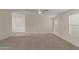 Spacious living room with plush carpet, neutral paint and modern ceiling fan at 11912 N Thunderbird Rd, Maricopa, AZ 85139