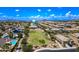 Aerial view of a residential neighborhood showcasing community green spaces and mountain views at 1344 N Claiborne --, Mesa, AZ 85205