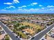 Expansive community aerial view showcasing abundant housing, a lush green park and blue sky at 1344 N Claiborne --, Mesa, AZ 85205
