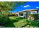 Backyard showcasing lush green artificial turf and mature landscaping with a covered patio at 1344 N Claiborne --, Mesa, AZ 85205