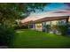 Lush backyard with artificial turf, mature trees, and covered patio, perfect for entertaining at 1344 N Claiborne --, Mesa, AZ 85205