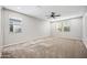 Spacious bedroom featuring neutral tones, plush carpet, and a ceiling fan at 1344 N Claiborne --, Mesa, AZ 85205