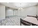 Unfurnished bedroom with wood-look floors, neutral walls and decorative chandelier at 1344 N Claiborne --, Mesa, AZ 85205