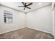Bright bedroom with a ceiling fan, plush carpet, and a window providing natural light at 1344 N Claiborne --, Mesa, AZ 85205