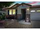 Inviting front entrance featuring stone accents and a covered porch with warm lighting at 1344 N Claiborne --, Mesa, AZ 85205