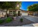 Charming single-story home featuring stone accents, a two-car garage, and a well-maintained front yard at 1344 N Claiborne --, Mesa, AZ 85205
