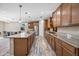 Open kitchen with a large island, stainless steel appliances, and wood cabinets, perfect for cooking at 1344 N Claiborne --, Mesa, AZ 85205