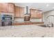 Modern kitchen showcasing granite countertops, stainless steel appliances, and wood cabinet storage at 1344 N Claiborne --, Mesa, AZ 85205