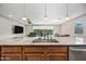 Kitchen featuring a stainless steel sink, granite countertops, and open view to living spaces at 1344 N Claiborne --, Mesa, AZ 85205