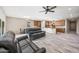 Open-concept living space with modern kitchen, dining area, comfortable seating, and stylish wood-look tile floors at 1344 N Claiborne --, Mesa, AZ 85205