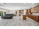 Open-concept living space featuring a modern kitchen, dining area, and comfortable seating with wood-look tile floors at 1344 N Claiborne --, Mesa, AZ 85205