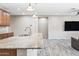 Open-concept kitchen and living area with granite countertops and stainless steel sink at 1344 N Claiborne --, Mesa, AZ 85205