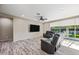 Bright living room with access to backyard featuring wood-look tile floors and comfortable seating at 1344 N Claiborne --, Mesa, AZ 85205