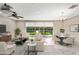 Virtually staged living room featuring comfortable seating, dining area, and backyard view at 1344 N Claiborne --, Mesa, AZ 85205