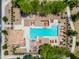 Aerial view of a community pool surrounded by lounge chairs, tables, umbrellas and green space at 1344 N Claiborne --, Mesa, AZ 85205