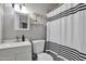 Clean bathroom with modern fixtures, vanity, toilet, and stylish shower curtain at 13913 N 2Nd Ave, El Mirage, AZ 85335