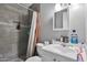 Bathroom with a tiled shower, toilet, and vanity with a sink at 13913 N 2Nd Ave, El Mirage, AZ 85335