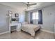 Bedroom with tile floors, ample natural light, ceiling fan, and modern decor at 13913 N 2Nd Ave, El Mirage, AZ 85335