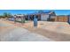 The exterior with the driveway, garage and fenced front yard at 13913 N 2Nd Ave, El Mirage, AZ 85335