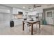 Bright kitchen featuring white cabinetry, stainless steel appliances, and a dining table at 13913 N 2Nd Ave, El Mirage, AZ 85335
