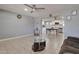 Open living room with tile flooring and view into the modern kitchen space at 13913 N 2Nd Ave, El Mirage, AZ 85335