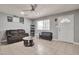 Cozy living room featuring tile flooring, a ceiling fan, and lots of natural light at 13913 N 2Nd Ave, El Mirage, AZ 85335